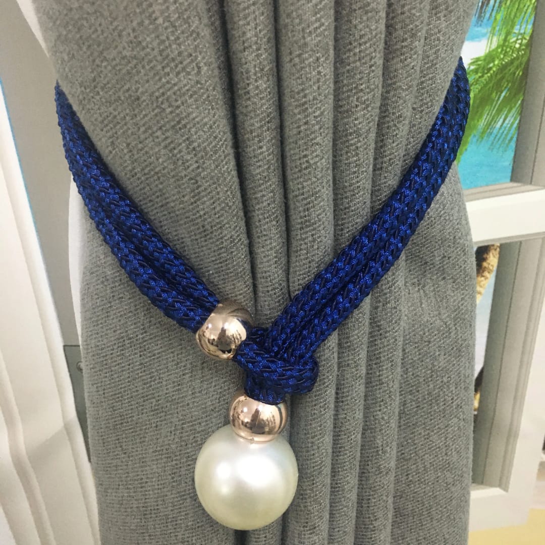 A PAIR OF ELEGANT CURTAIN HOLDERS